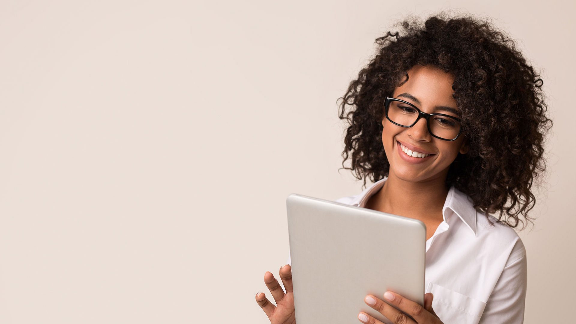 woman holding a tablet and smiling