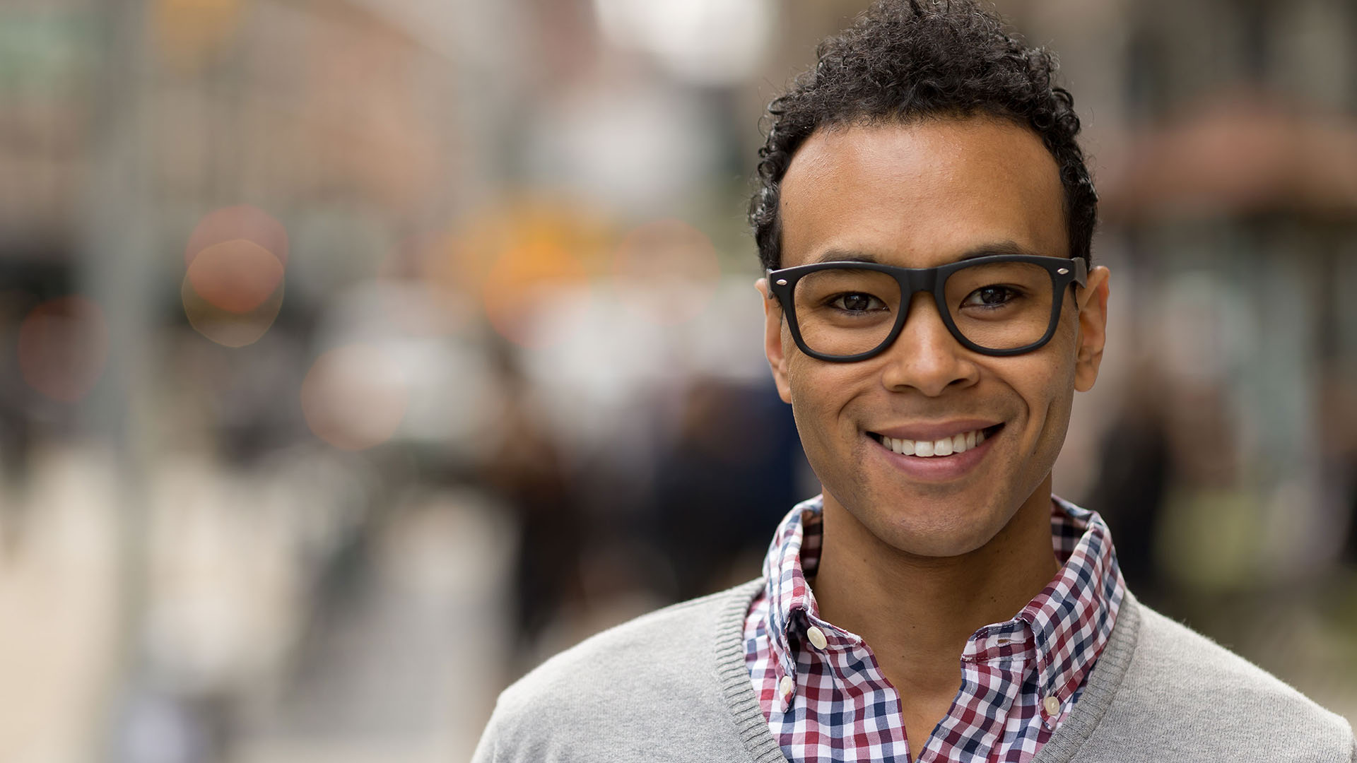 man of color with nice glasses smiling